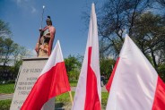 Biało czerwone flagi - w tle figura św. Floriana.